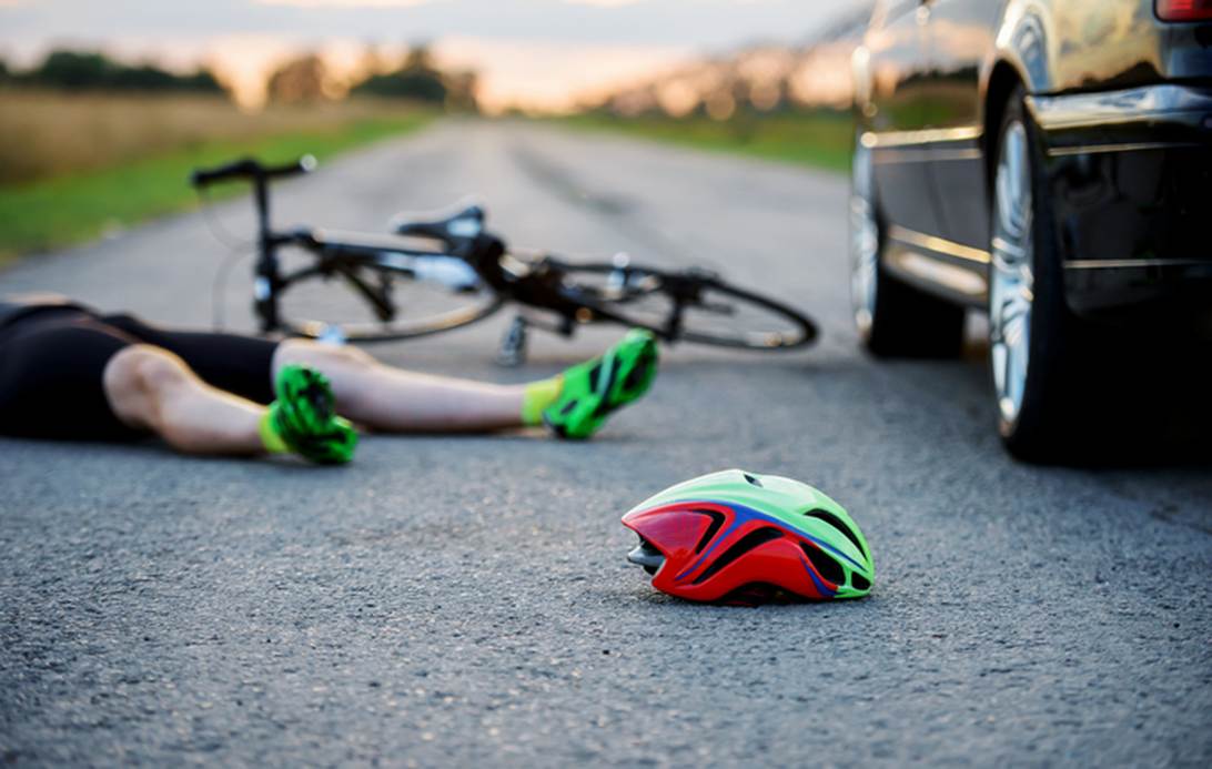 A person lying on the ground next to a bicycle
AI-generated content may be incorrect.